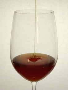 Amber honey filling a wine glass