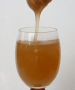 wine glass of amber colored honey