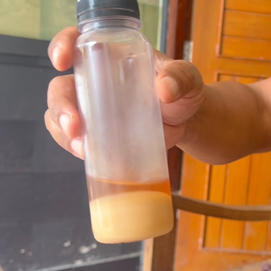 Jar of honey with a white bottom layer of royal jelly