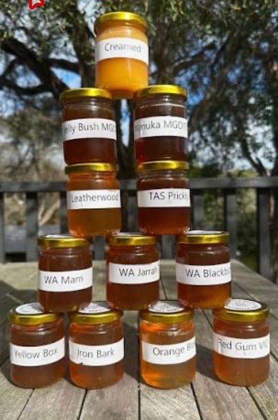 A stacked pyramid of honey jars.